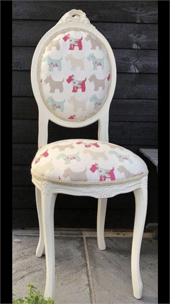 A quirky trio of small white painted bedroom chair, stool and cushion.